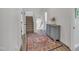 Hallway leading to staircase with rug, hardwood flooring, and rustic cabinet at 2300 Ginger Gold Court, Apex, NC 27539