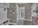 Charming hallway with floral wallpaper, built-in bench, and a glimpse into a bright, inviting space at 2300 Ginger Gold Court, Apex, NC 27539