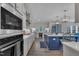 Bright kitchen with an island, stainless steel appliances, and easy access to other living spaces at 2300 Ginger Gold Court, Apex, NC 27539