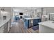 Open-concept kitchen featuring a large island, modern appliances, and a seamless transition to the living area at 2300 Ginger Gold Court, Apex, NC 27539