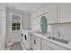 Well-lit laundry room with modern appliances and ample counter space at 2300 Ginger Gold Court, Apex, NC 27539