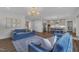 Inviting living room with comfortable blue sofas, hardwood floors, and a view of the kitchen at 2300 Ginger Gold Court, Apex, NC 27539