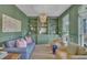Stylish living room with custom shelving, elegant chandelier, and comfortable seating at 2300 Ginger Gold Court, Apex, NC 27539