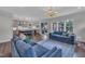 Spacious living room with comfortable blue sofas, hardwood floors, and a view of the kitchen at 2300 Ginger Gold Court, Apex, NC 27539