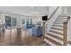Spacious living room with hardwood floors, comfortable blue sofas, and stairs at 2300 Ginger Gold Court, Apex, NC 27539