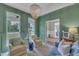 Chic living room with built-in shelving, eye-catching chandelier and sun-filled windows at 2300 Ginger Gold Court, Apex, NC 27539