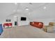 Spacious living room featuring an accent sofa, recessed lighting, and an adjoining bathroom for convenience at 2300 Ginger Gold Court, Apex, NC 27539