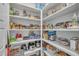 Well-organized walk-in pantry featuring white shelving stocked with a variety of food and cooking essentials at 2300 Ginger Gold Court, Apex, NC 27539