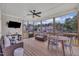 Inviting screened porch with comfortable seating, a ceiling fan, and views of the surrounding neighborhood at 2300 Ginger Gold Court, Apex, NC 27539
