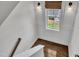 Well-lit stairway with hardwood floors and elegant wainscoting leading to the second floor at 2300 Ginger Gold Court, Apex, NC 27539
