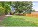 Expansive backyard featuring a beautiful lawn, privacy fence, and mature tree offering ample shade at 2318 E Main St, Durham, NC 27703