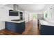 Modern kitchen with stainless steel appliances, white countertops, and dark blue cabinetry at 2318 E Main St, Durham, NC 27703