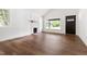 Bright living room featuring a decorative fireplace, large windows, and hardwood floors at 2318 E Main St, Durham, NC 27703