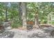 Tranquil backyard featuring a wooden swing suspended between mature trees, creating a relaxing outdoor space at 2334 Dawn Trl, Durham, NC 27712