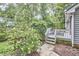 This backyard features a deck, patio, and mature trees at 2334 Dawn Trl, Durham, NC 27712