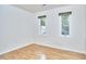 Bright bedroom with hardwood floors and two windows providing natural light at 2334 Dawn Trl, Durham, NC 27712