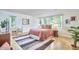 Comfortable bedroom with wood floors, many windows, and inviting rug at 2334 Dawn Trl, Durham, NC 27712