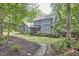Two-story home with a red door and manicured lawn set in a wooded area for a secluded feel at 2334 Dawn Trl, Durham, NC 27712