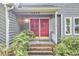Charming front entrance features a striking red double door and well-maintained landscaping at 2334 Dawn Trl, Durham, NC 27712