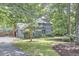 Lush greenery surrounds this two-story home, creating a private setting with mature trees and manicured lawn at 2334 Dawn Trl, Durham, NC 27712