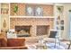 Cozy living room features a brick fireplace with built-in shelves, perfect for relaxation at 2334 Dawn Trl, Durham, NC 27712