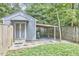 Backyard outbuilding has convenient carport and wooden privacy fence offering both storage and secluded parking at 2334 Dawn Trl, Durham, NC 27712