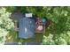 Aerial view of a home with a backyard deck, patio, mature trees, and a fenced backyard at 2410 Wade Hampton Rd, Hillsborough, NC 27278
