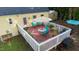 Aerial view of a backyard deck with patio furniture and a well-maintained lawn at 2410 Wade Hampton Rd, Hillsborough, NC 27278