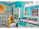 Bright bathroom featuring a colorful sunflower shower curtain and a vanity with plenty of storage at 2410 Wade Hampton Rd, Hillsborough, NC 27278