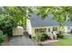 Charming home featuring yellow siding, brick stairs, an American flag, a shed, and a well-manicured yard at 2410 Wade Hampton Rd, Hillsborough, NC 27278