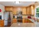 Functional kitchen with granite countertops, stainless steel appliances, wood cabinets, and tile backsplash at 2410 Wade Hampton Rd, Hillsborough, NC 27278