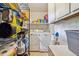 Organized laundry room with shelving, washer, dryer, and plenty of storage space at 2410 Wade Hampton Rd, Hillsborough, NC 27278