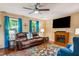 Bright living room with a fireplace, hardwood floors, ample natural light, and blue curtains at 2410 Wade Hampton Rd, Hillsborough, NC 27278