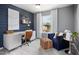 Inviting home office with a modern desk, stylish chair, and a comfortable blue chair at 2769 Cassius Dr, Apex, NC 27502