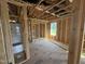 Unfinished bathroom featuring stud walls and a white tub at 29 Chloe Ct, Selma, NC 27576