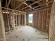 Unfinished bedroom showcasing exposed ductwork and framing, with light coming in from a window at 29 Chloe Ct, Selma, NC 27576