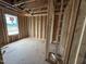 Unfinished bedroom showing the stud framing and light coming in from a window at 29 Chloe Ct, Selma, NC 27576