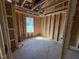 Unfinished bedroom featuring stud walls and a plywood subfloor at 29 Chloe Ct, Selma, NC 27576
