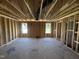 Unfinished bedroom featuring stud walls and a plywood subfloor at 29 Chloe Ct, Selma, NC 27576