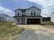 New two-story home with visible framing awaits completion with a two-car garage and landscaped yard at 29 Chloe Ct, Selma, NC 27576