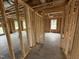 Unfinished hallway showcasing 2x4 stud framing and open doorway at 29 Chloe Ct, Selma, NC 27576