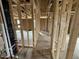 Unfinished hallway showcasing 2x4 stud framing and exposed ductwork at 29 Chloe Ct, Selma, NC 27576
