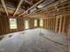 Spacious living room framing, features large windows for natural light and rear door access at 29 Chloe Ct, Selma, NC 27576