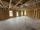 Unfinished living room showing the 2x4 construction with natural light coming through multiple windows at 29 Chloe Ct, Selma, NC 27576