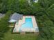 Aerial view of community pool featuring plenty of seating, lush trees, and well-manicured grounds at 2920 Barrymore St # 106, Raleigh, NC 27603