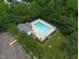 Aerial view of community pool featuring plenty of seating and lush trees around the property at 2920 Barrymore St # 106, Raleigh, NC 27603