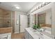 Bathroom featuring double sinks, a soaking tub, and a stand up shower at 2920 Barrymore St # 106, Raleigh, NC 27603