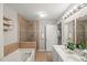 Bathroom featuring double sinks, a soaking tub, and a stand up shower at 2920 Barrymore St # 106, Raleigh, NC 27603