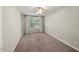 Bedroom featuring a window with curtains, neutral walls, and carpet flooring at 2920 Barrymore St # 106, Raleigh, NC 27603