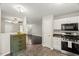 Bright kitchen with white cabinets and access to the living area with dark flooring at 2920 Barrymore St # 106, Raleigh, NC 27603